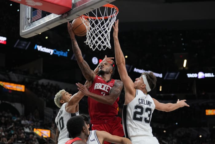 Rockets forward Cam Whitmore shoots between San Antonio Spurs forwards Jeremy Sochan (10) and Zach Collins in the second half at the Frost Bank Center.